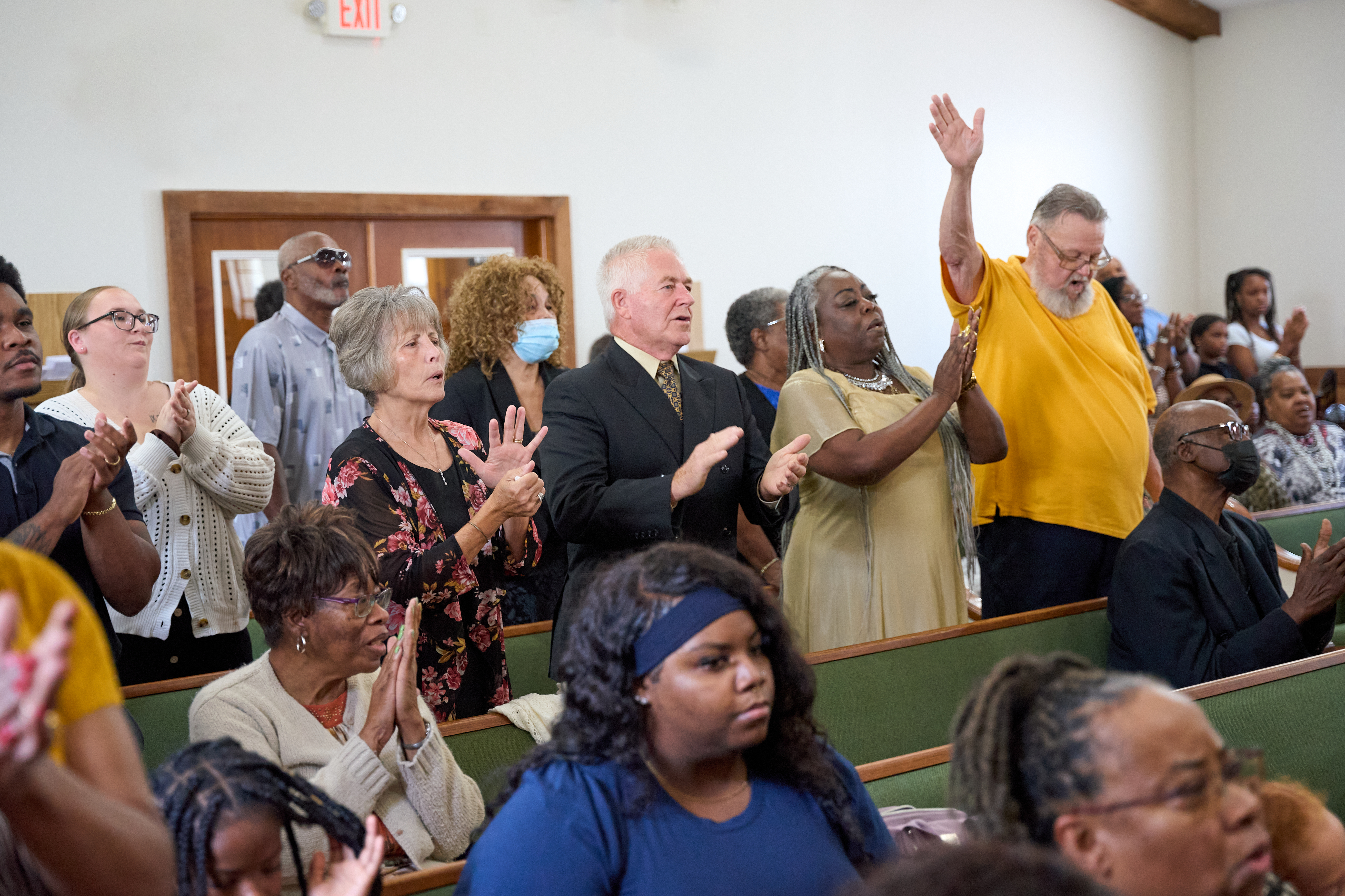 Congregation worshiping together with hands raised